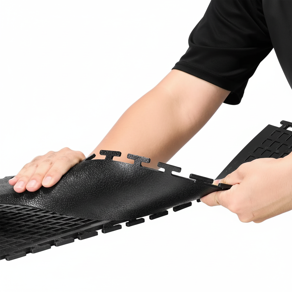 Person snapping black interlocking edge transition strip onto garage floor mat